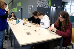 Grupa przy stole wyszywa kartki